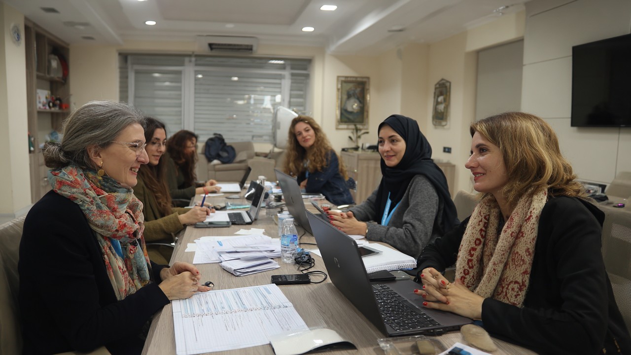 Female entrepreneurs and government representatives collaborating in a meeting, discussing support programs for women-led businesses in Turkey.