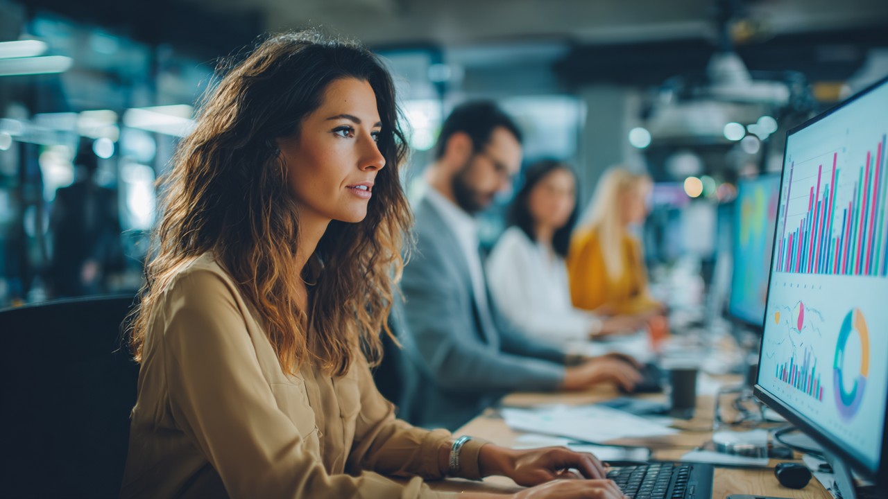 Modern office with diverse professional women analyzing business charts and data trends on digital screens, highlighting female entrepreneurship growth in Turkey.